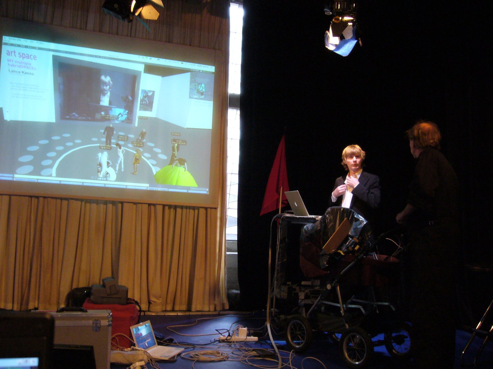 NB1 Studio A — Second Life projected onto the stage, presenter at the lectern